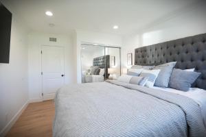 a bedroom with a large bed with a large headboard at Destination #47 in Orange +34 photos