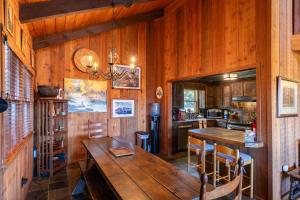 a kitchen with wooden walls and a wooden table and chairs at On Any Sunday in Blowing Rock