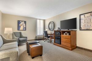 a living room with a couch and a flat screen tv at Drury Inn & Suites Springfield MO in Springfield