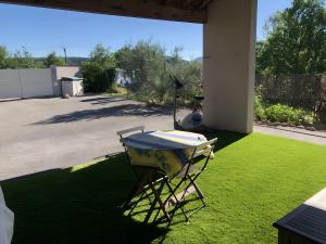a table sitting on a lawn in a yard at Chambre Ephedra in Sampzon +2 photos