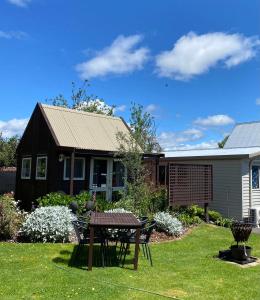 a house with a picnic table in the yard at Evermore Stay in Richmond