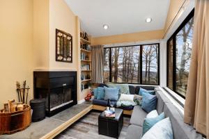 a living room with a couch and a fireplace at Dobie 21 With Wintergreen Advantage in Mount Torry Furnace