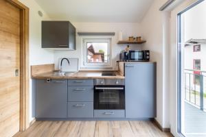 a kitchen with stainless steel appliances and a window at Ferienwohnung Morgensonne in Bad Feilnbach