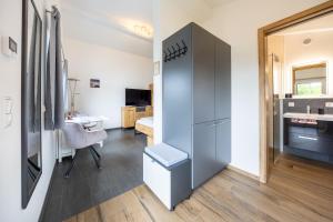 a small room with a refrigerator and a bedroom at Ferienwohnung Morgensonne in Bad Feilnbach