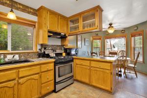 a kitchen with wooden cabinets and a stove top oven at Idle hours inn #1945 in Big Bear City