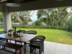 a wooden table and chairs on a patio at 41 South in Mtunzini