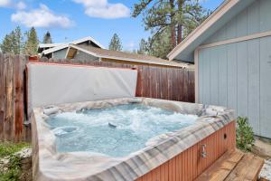 a hot tub in a backyard with a fence at Idle hours inn #1945 in Big Bear City +3 photos