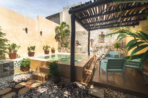 a patio with a hot tub in a building at Casa Mariano Merida by WoWay Experiences in Mérida
