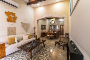 a living room with a white couch and a table at Casa Mariano Merida by WoWay Experiences in Mérida