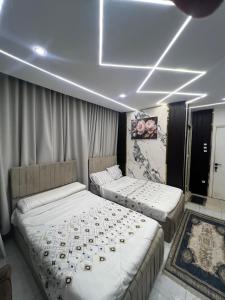 two beds sitting in a room with aception at Miracle Pyramids View Hotel in Giza