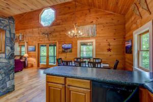a log cabin with a kitchen and dining room at Bella Woods Cabin in Fleetwood