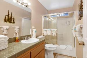 a bathroom with a toilet and a shower and a sink at Castle Glen Gem #2220 in Big Bear Lake +29 photos