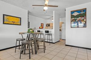 a kitchen and dining room with a table and stools at Balcony Pet-friendly Parking Leisure in Beltran