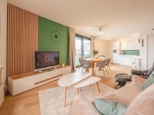 a living room with a television and a table at Delfien A in Galopen