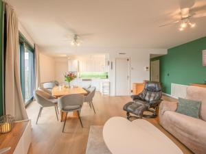 a living room with a table and chairs at Delfien A in Galopen +10 photos