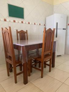 a dining room table with chairs and a refrigerator at Excelente casa na Nova Maraba in Marabá +6 photos