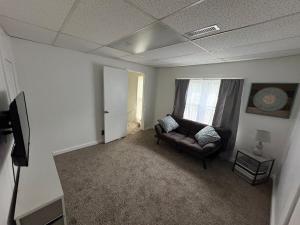 a living room with a couch and a window at 2 Story Home in the Noto Arts District in Topeka