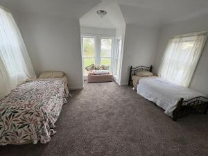 a bedroom with two beds and a window at 2 Story Home in the Noto Arts District in Topeka