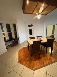 a dining room with a wooden table and chairs at 2 Story Home in the Noto Arts District in Topeka +9 photos
