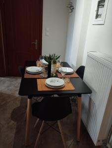 a table with plates and wine glasses on it at Gianis Homme in Alexandroupoli +13 photos