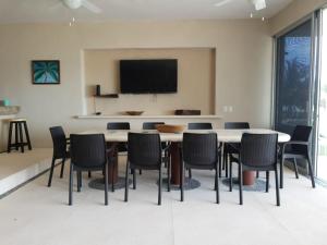 a conference room with a table and chairs at New Beachfront Villa in Playa Blanca in Zihuatanejo
