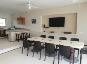 a room with a table and chairs and a kitchen at New Beachfront Villa in Playa Blanca in Zihuatanejo +12 photos