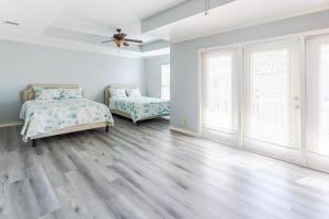 a bedroom with two beds and a ceiling fan at Entire House - Spacious 3 Bedroom on the Island in Corpus Christi