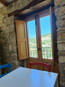 a room with a window and a table and chairs at A Casuzza in Caronia