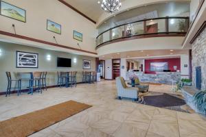 a lobby at a hospital with chairs and a fireplace at Best Western Shelby Inn & Suites in Shelby