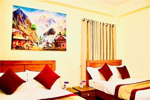 a bedroom with two beds and a painting on the wall at Himalayan Tranquil Stay in Burhānilkantha