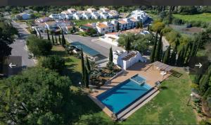 an aerial view of a villa with a swimming pool at Casa do Sol and Golf - Vilamoura in Estibeira