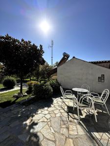 a patio with a table and chairs on a stone patio at Traditional Memories 2 in Tríkala
