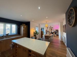 a kitchen with a counter top and a dining room at West Lodge - Buxton in Buxton