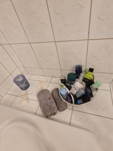 a bathroom with a bath tub with a basket of items at Nordlicht in Hagen im Bremischen +21 photos