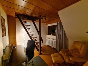 a living room with a spiral staircase in a house at Nordlicht in Hagen im Bremischen