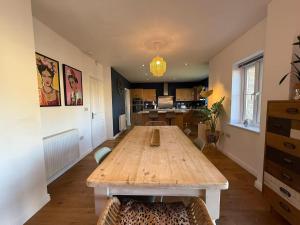 a kitchen with a wooden table in a room at West Lodge - Buxton in Buxton