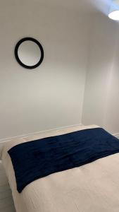 a bed in a room with a mirror on the wall at Modern 1-Bed Flat in Crystal Palace Sydenham in Sydenham