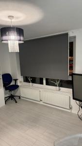 a living room with a large flat screen tv at Modern 1-Bed Flat in Crystal Palace Sydenham in Sydenham