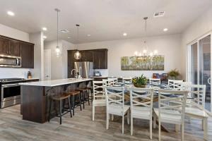 a kitchen and dining room with a table and chairs at 31| Pool Palace in St George with Snow Canyon View in Santa Clara +63 photos