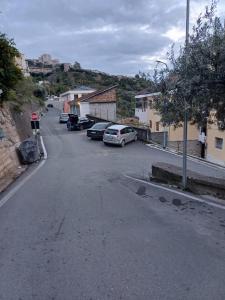 a street with cars parked on the side of a hill at Gledys House in Krujë