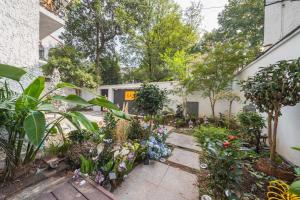 a garden with flowers and plants in a building at Tonight Homestay South Shanxi Road Shanghai in Shanghai