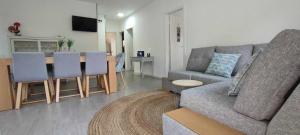 a living room with a couch and a table at Casa Do Cabo Ponte De Lima - Jacuzzi And Pool in Ponte de Lima