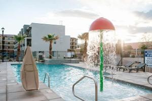 a fountain in the middle of a swimming pool at 19-20| 2 Homes in St. George Green Valley with Community Pool in St. George