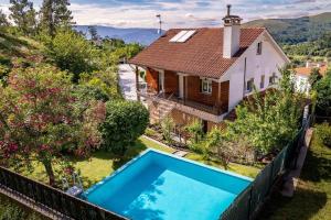 an aerial view of a house with a swimming pool at Casa Das Fontes Ponte De Lima - Jaccuzzi And Pool in Ponte de Lima