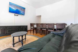 a living room with a couch and a table and chairs at Casa Das Fontes Ponte De Lima - Jaccuzzi And Pool in Ponte de Lima