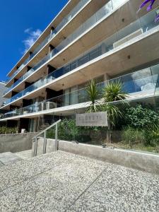 a building with a street sign in front of it at An oasis in the middle of the noise in Punta del Este