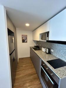 a kitchen with white cabinets and a counter top at An oasis in the middle of the noise in Punta del Este