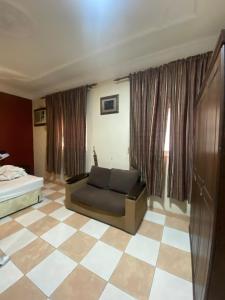 a living room with a couch and a checkered floor at أللورا زون - Alora Zone in Abha