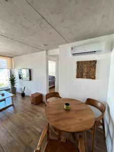 a living room with a wooden table and chairs at An oasis in the middle of the noise in Punta del Este