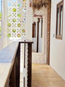 a kitchen with a counter top and a mirror at Manay Flats in Jericoacoara